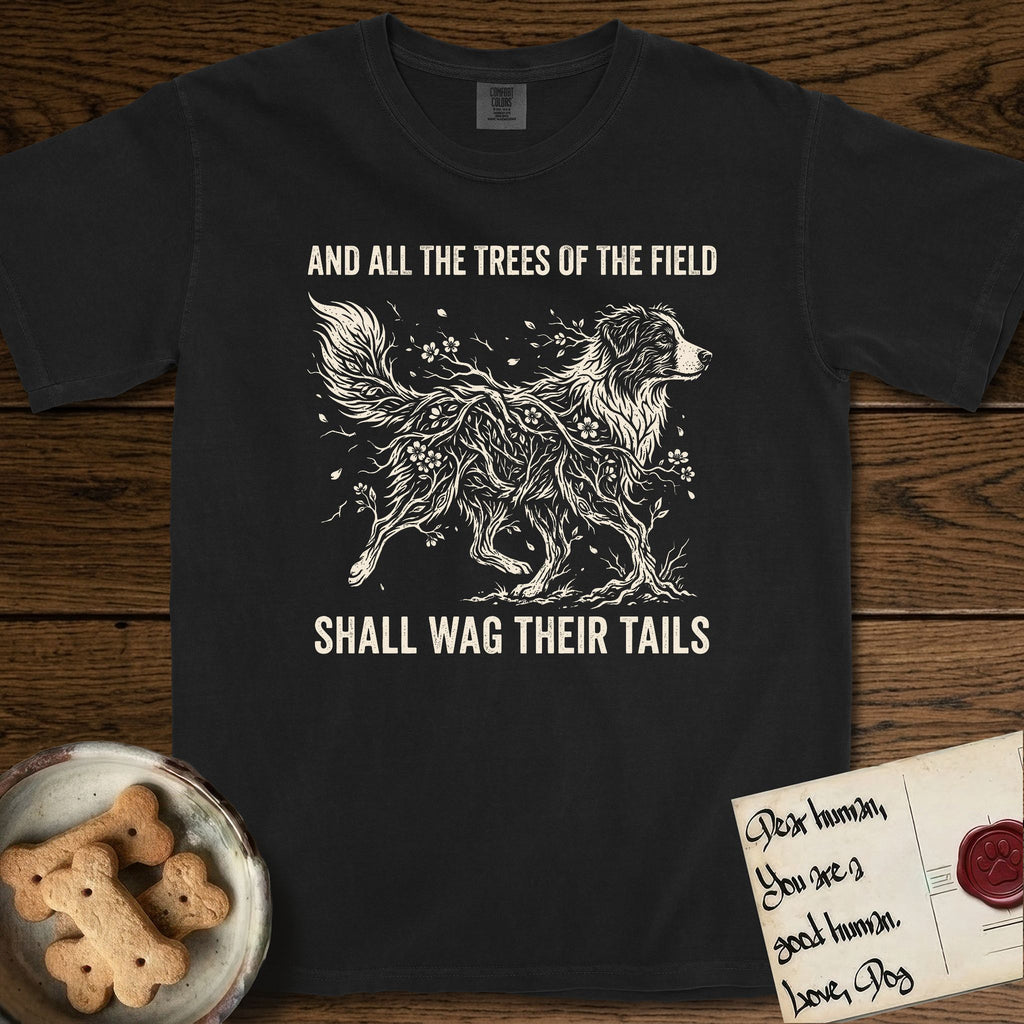 Trees of the Field Australian Shepherd T-Shirt flat lay in Black, featuring a vintage woodcut illustration of an Australian Shepherd formed of flowering cherry branches, mid-stride, with the words And All the Trees of the Field Shall Wag Their Tails.