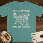 Trees of the Field Australian Shepherd T-Shirt flat lay in Blue Spruce, featuring a vintage woodcut illustration of an Australian Shepherd formed of flowering cherry branches, mid-stride, with the words And All the Trees of the Field Shall Wag Their Tails.