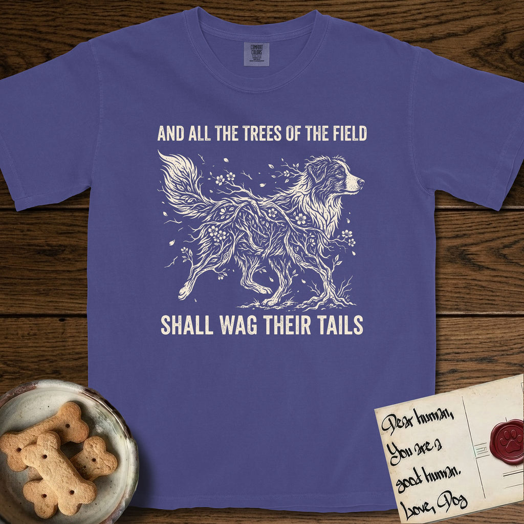 Trees of the Field Australian Shepherd T-Shirt flat lay in Grape, featuring a vintage woodcut illustration of an Australian Shepherd formed of flowering cherry branches, mid-stride, with the words And All the Trees of the Field Shall Wag Their Tails.