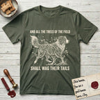 Trees of the Field Australian Shepherd T-Shirt flat lay in Heather Military Green, featuring a vintage woodcut illustration of an Australian Shepherd formed of flowering cherry branches, mid-stride, with the words And All the Trees of the Field Shall Wag Their Tails.