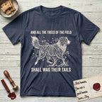 Trees of the Field Australian Shepherd T-Shirt flat lay in Heather Navy, featuring a vintage woodcut illustration of an Australian Shepherd formed of flowering cherry branches, mid-stride, with the words And All the Trees of the Field Shall Wag Their Tails.