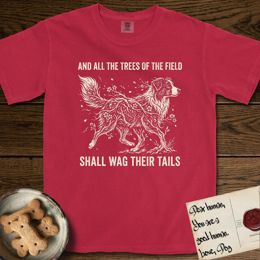 Trees of the Field Australian Shepherd T-Shirt flat lay in Red, featuring a vintage woodcut illustration of an Australian Shepherd formed of flowering cherry branches, mid-stride, with the words And All the Trees of the Field Shall Wag Their Tails.