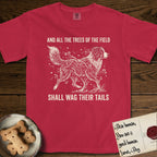 Trees of the Field Australian Shepherd T-Shirt flat lay in Red, featuring a vintage woodcut illustration of an Australian Shepherd formed of flowering cherry branches, mid-stride, with the words And All the Trees of the Field Shall Wag Their Tails.