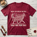 Trees of the Field German Shepherd T-Shirt flat lay in Antique Cherry Red, featuring a vintage woodcut illustration of a German Shepherd formed of oak branches with acorns, mid-stride, with the words And All the Trees of the Field Shall Wag Their Tails.