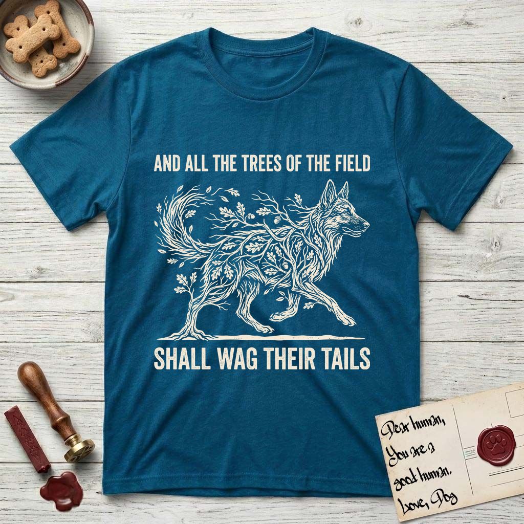 Trees of the Field German Shepherd T-Shirt flat lay in Antique Sapphire, featuring a vintage woodcut illustration of a German Shepherd formed of oak branches with acorns, mid-stride, with the words And All the Trees of the Field Shall Wag Their Tails.