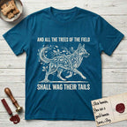 Trees of the Field German Shepherd T-Shirt flat lay in Antique Sapphire, featuring a vintage woodcut illustration of a German Shepherd formed of oak branches with acorns, mid-stride, with the words And All the Trees of the Field Shall Wag Their Tails.
