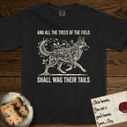 Trees of the Field German Shepherd T-Shirt flat lay in Black, featuring a vintage woodcut illustration of a German Shepherd formed of oak branches with acorns, mid-stride, with the words And All the Trees of the Field Shall Wag Their Tails.
