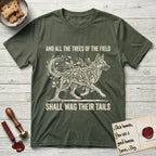 Trees of the Field German Shepherd T-Shirt flat lay in Heather Military Green, featuring a vintage woodcut illustration of a German Shepherd formed of oak branches with acorns, mid-stride, with the words And All the Trees of the Field Shall Wag Their Tails.