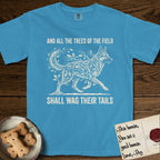 Trees of the Field German Shepherd T-Shirt flat lay in Royal Caribe, featuring a vintage woodcut illustration of a German Shepherd formed of oak branches with acorns, mid-stride, with the words And All the Trees of the Field Shall Wag Their Tails.