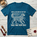 Trees of the Field Golden Retriever T-Shirt flat lay in Antique Sapphire, featuring a vintage woodcut illustration of a Golden Retriever formed of flowing willow branches, mid-stride, with the words And All the Trees of the Field Shall Wag Their Tails.