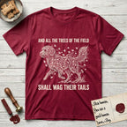 Trees of the Field Goldendoodle T-Shirt flat lay in Antique Cherry Red, featuring a vintage woodcut illustration of a Goldendoodle formed of ginkgo branches with fan-shaped leaves, mid-stride, with the words And All the Trees of the Field Shall Wag Their Tails.