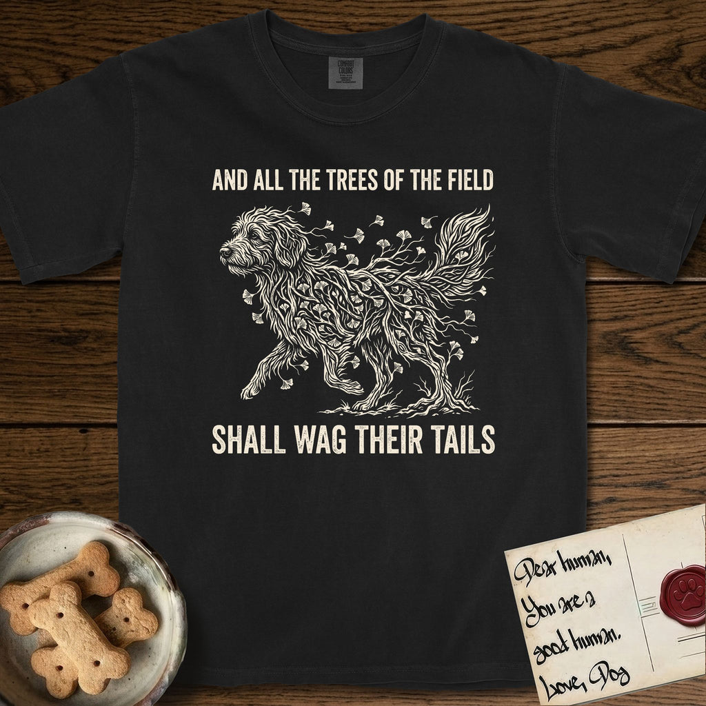 Trees of the Field Goldendoodle T-Shirt flat lay in Black, featuring a vintage woodcut illustration of a Goldendoodle formed of ginkgo branches with fan-shaped leaves, mid-stride, with the words And All the Trees of the Field Shall Wag Their Tails.