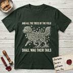 Trees of the Field Goldendoodle T-Shirt flat lay in Forest Green, featuring a vintage woodcut illustration of a Goldendoodle formed of ginkgo branches with fan-shaped leaves, mid-stride, with the words And All the Trees of the Field Shall Wag Their Tails.