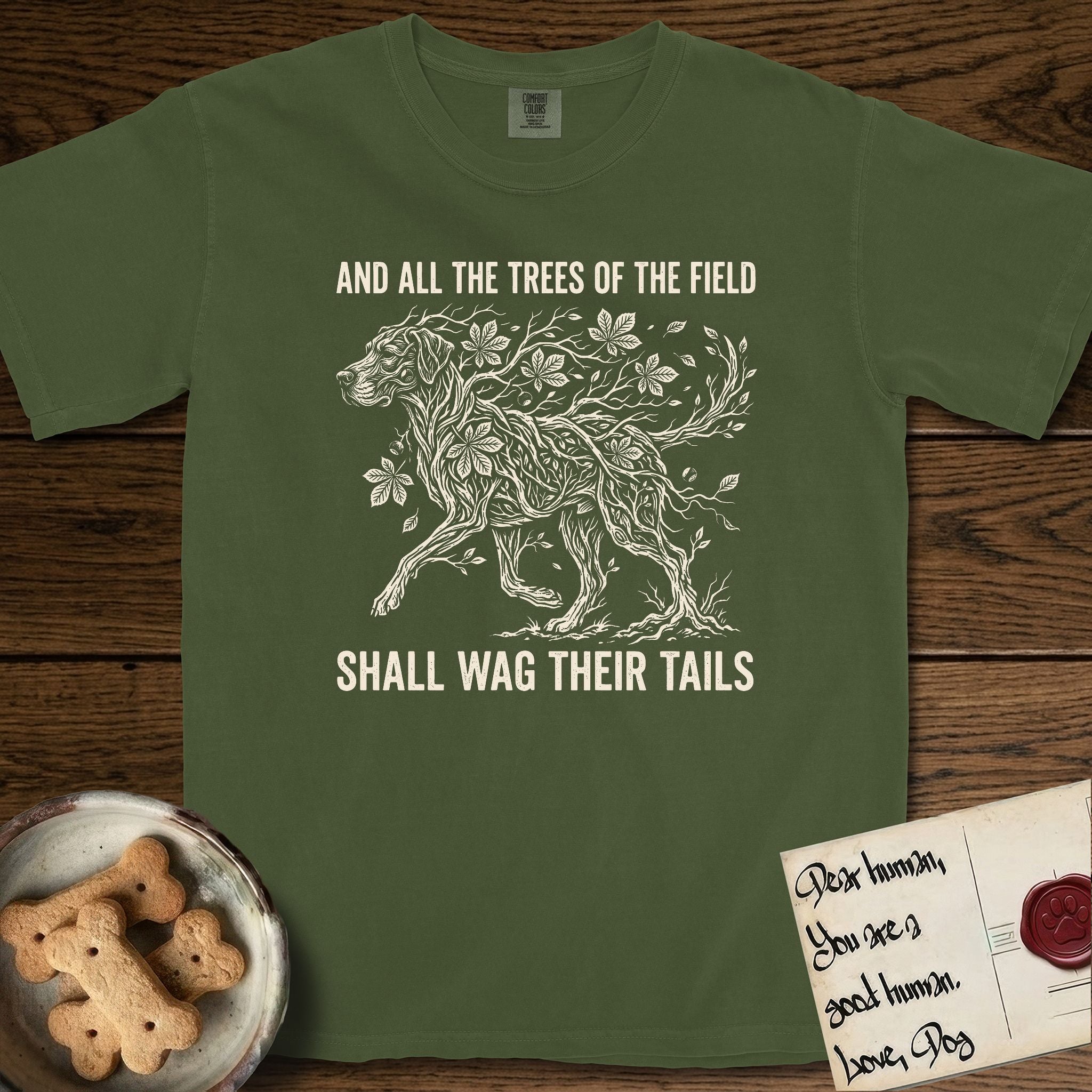 Trees of the Field Great Dane T-Shirt flat lay in Hemp, featuring a vintage woodcut illustration of a Great Dane formed of horse chestnut branches and leaves, mid-stride, with the words And All the Trees of the Field Shall Wag Their Tails.