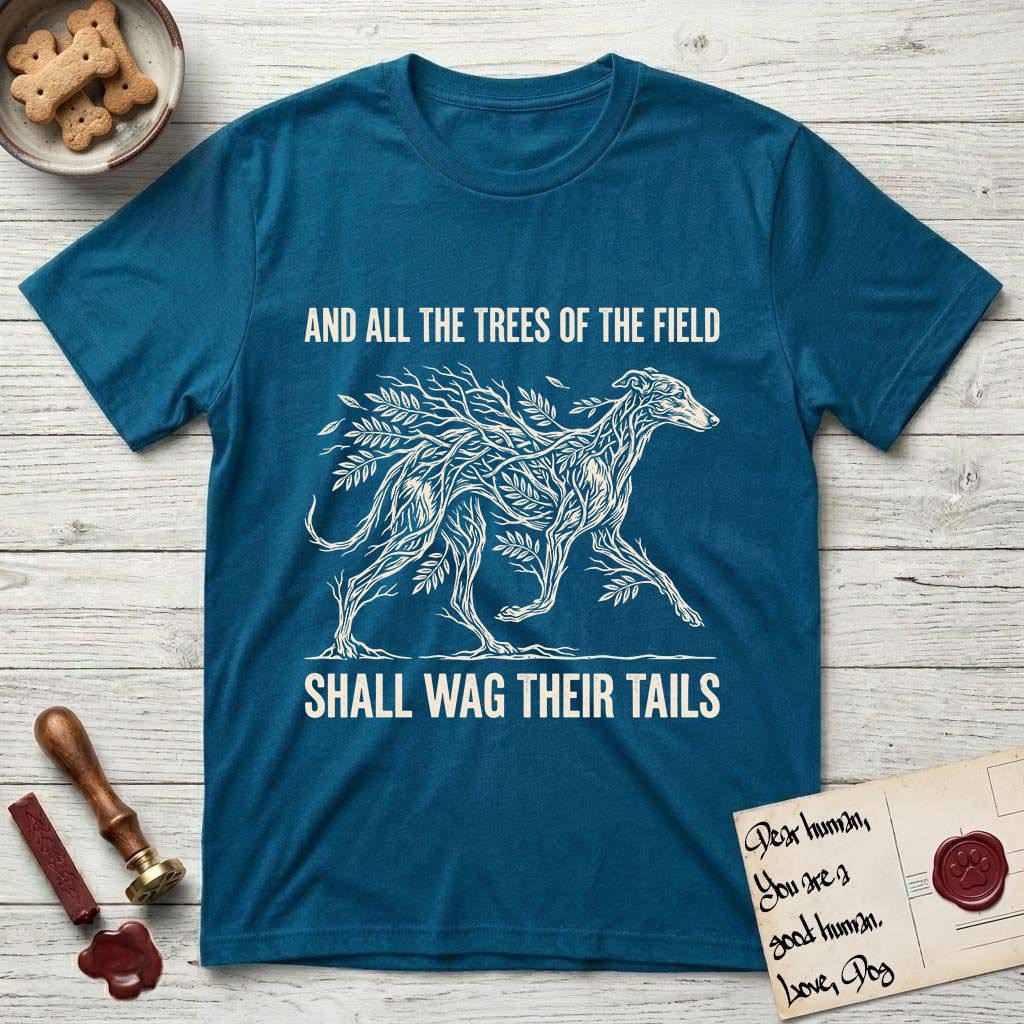 Trees of the Field Greyhound T-Shirt flat lay in Antique Sapphire, featuring a vintage woodcut illustration of a Greyhound formed of ash branches with streaming leaves, mid-stride, with the words And All the Trees of the Field Shall Wag Their Tails.