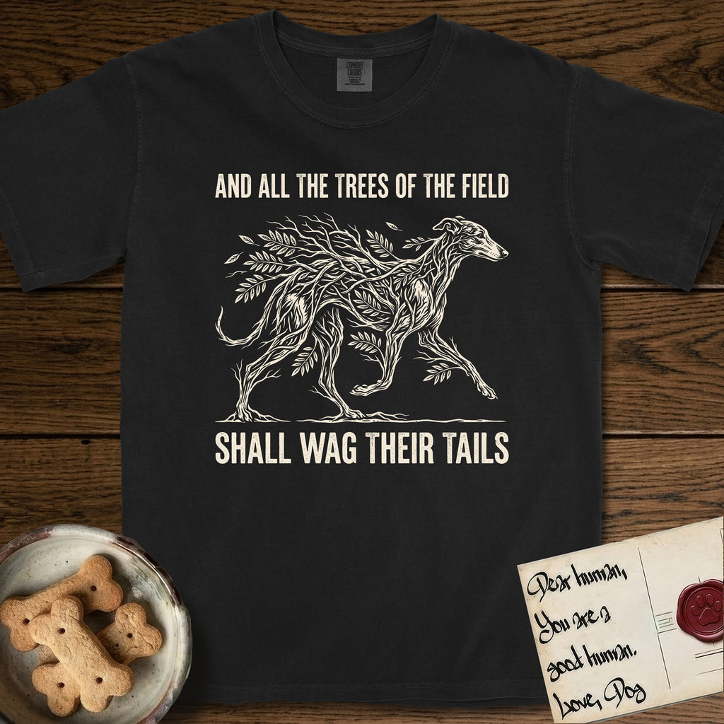 Trees of the Field Greyhound T-Shirt flat lay in Black, featuring a vintage woodcut illustration of a Greyhound formed of ash branches with streaming leaves, mid-stride, with the words And All the Trees of the Field Shall Wag Their Tails.