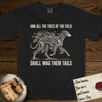 Trees of the Field Greyhound T-Shirt flat lay in Black, featuring a vintage woodcut illustration of a Greyhound formed of ash branches with streaming leaves, mid-stride, with the words And All the Trees of the Field Shall Wag Their Tails.