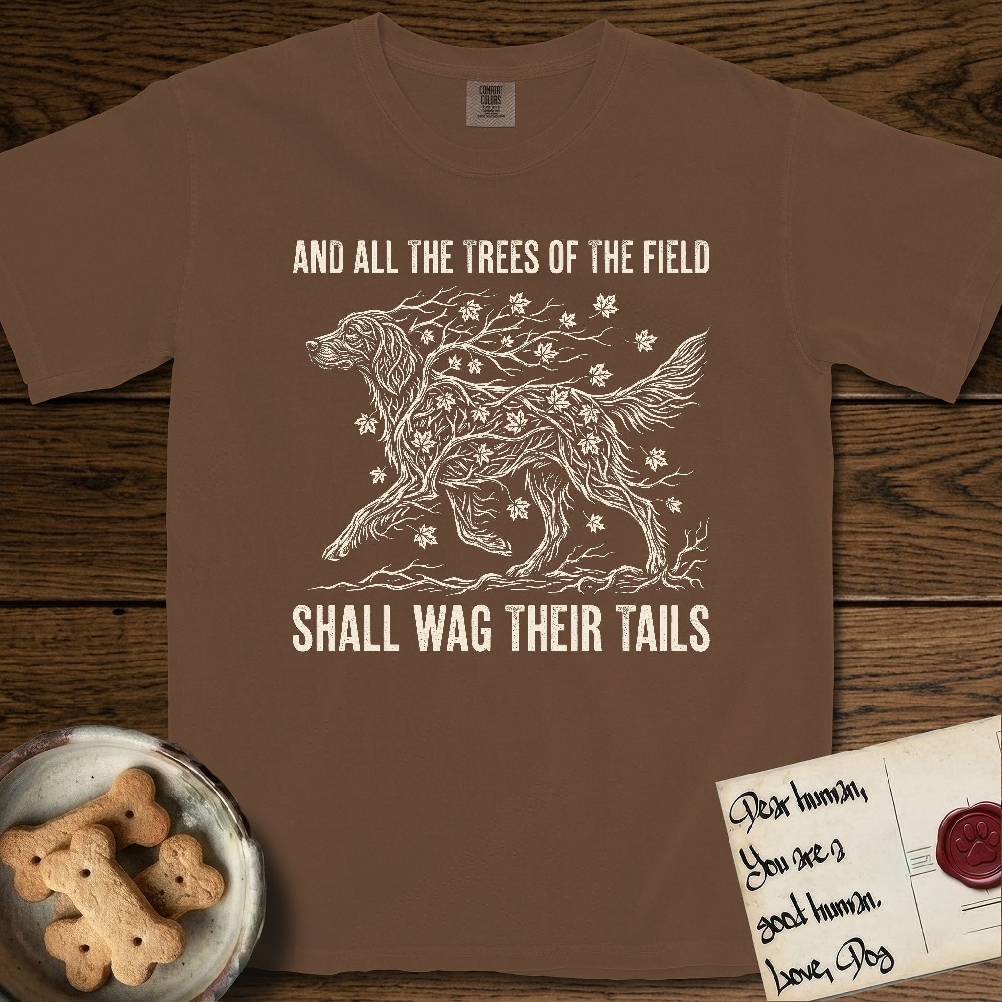 Trees of the Field Irish Setter T-Shirt flat lay in Espresso, featuring a vintage woodcut illustration of an Irish Setter formed of red maple branches with autumn leaves, mid-stride, with the words And All the Trees of the Field Shall Wag Their Tails.
