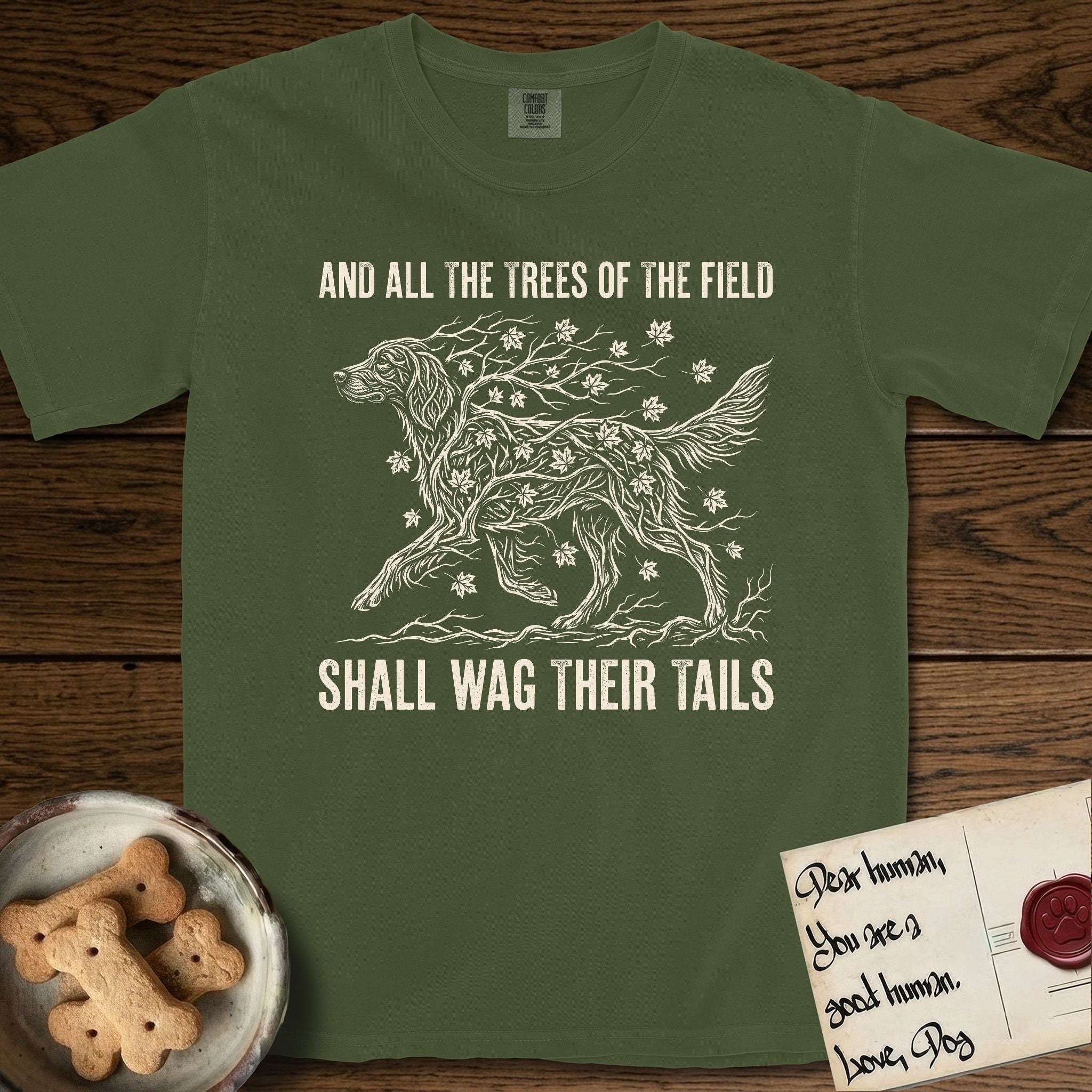 Trees of the Field Irish Setter T-Shirt flat lay in Hemp, featuring a vintage woodcut illustration of an Irish Setter formed of red maple branches with autumn leaves, mid-stride, with the words And All the Trees of the Field Shall Wag Their Tails.