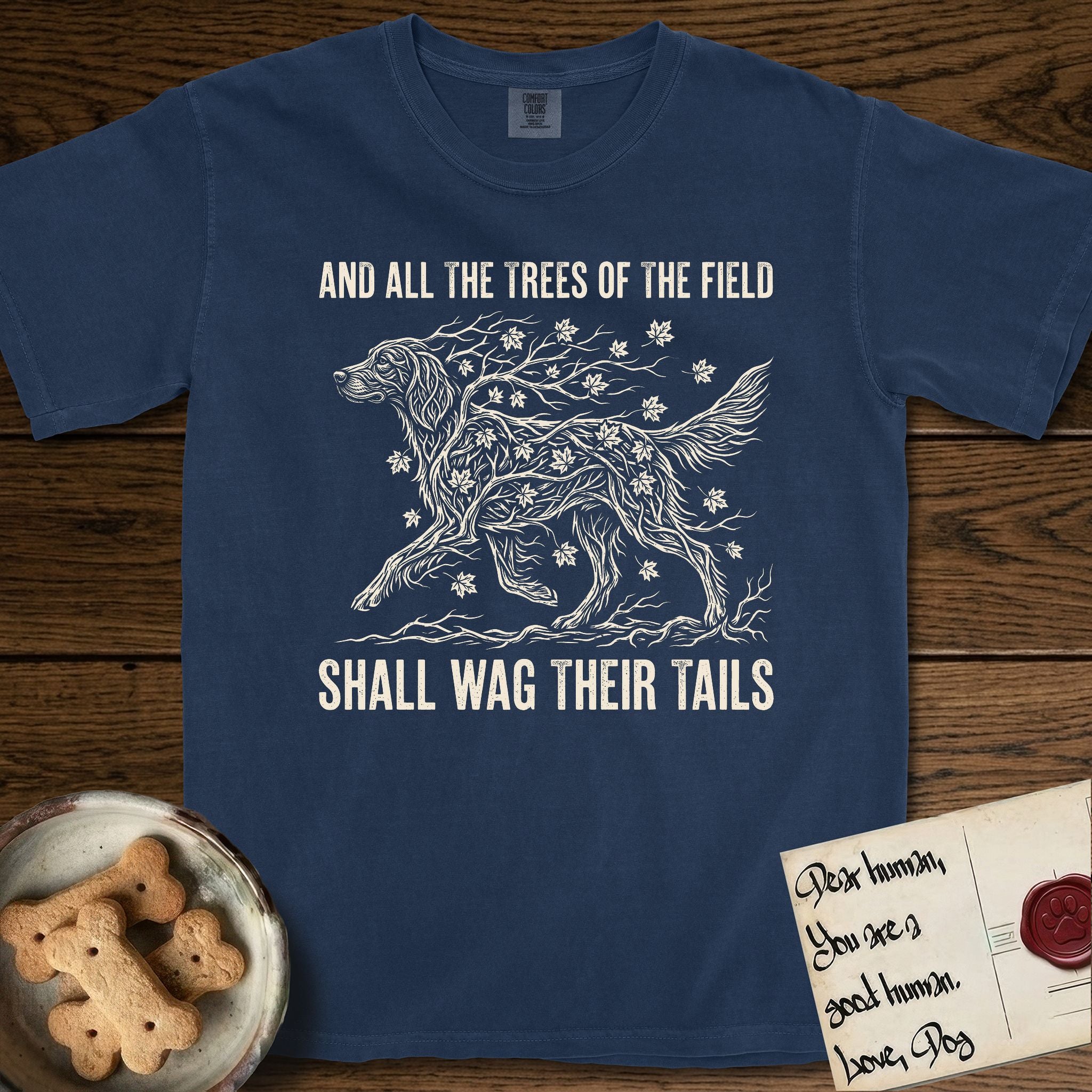 Trees of the Field Irish Setter T-Shirt flat lay in True Navy, featuring a vintage woodcut illustration of an Irish Setter formed of red maple branches with autumn leaves, mid-stride, with the words And All the Trees of the Field Shall Wag Their Tails.
