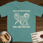 Trees of the Field Samoyed T-Shirt flat lay in Blue Spruce, featuring a vintage woodcut illustration of a Samoyed formed of white birch branches with catkins, mid-stride, with the words And All the Trees of the Field Shall Wag Their Tails.