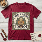 What a Friend We Have in Dog T-Shirt flat lay in Antique Cherry Red, featuring an Arts and Crafts tapestry illustration of a haloed Golden Retriever seated before a monastery, framed by an oak-leaf, acorn, and thistle border, with the word DOG below.