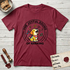 The Joyful Sound of Barking T-Shirt flat lay in Cardinal Red, featuring a flat vector cartoon emblem of a happy puppy with lifted ears surrounded by musical notes, ringed by the words The Joyful Sound of Barking.
