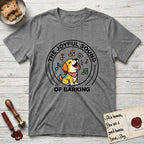 The Joyful Sound of Barking T-Shirt flat lay in Graphite Heather, featuring a flat vector cartoon emblem of a happy puppy with lifted ears surrounded by musical notes, ringed by the words The Joyful Sound of Barking.