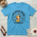 The Joyful Sound of Barking T-Shirt flat lay in Sky, featuring a flat vector cartoon emblem of a happy puppy with lifted ears surrounded by musical notes, ringed by the words The Joyful Sound of Barking.