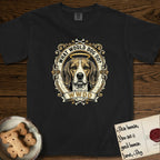 What Would Dog Do Beagle T-Shirt flat lay in Black, featuring a baroque scrollwork gold portrait medallion of a haloed Beagle with the question What Would Dog Do.