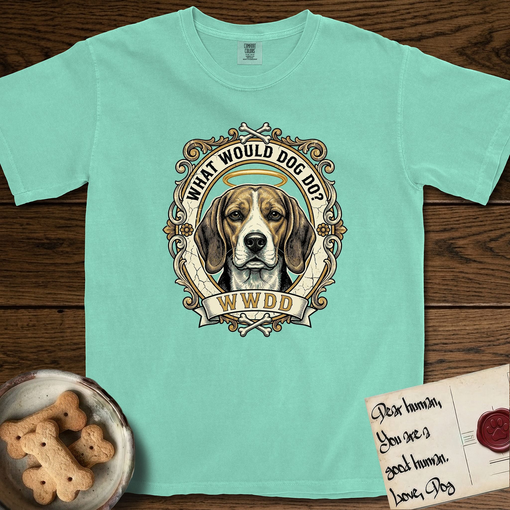 What Would Dog Do Beagle T-Shirt flat lay in Island Reef, featuring a baroque scrollwork gold portrait medallion of a haloed Beagle with the question What Would Dog Do.