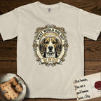 What Would Dog Do Beagle T-Shirt flat lay in Ivory, featuring a baroque scrollwork gold portrait medallion of a haloed Beagle with the question What Would Dog Do.