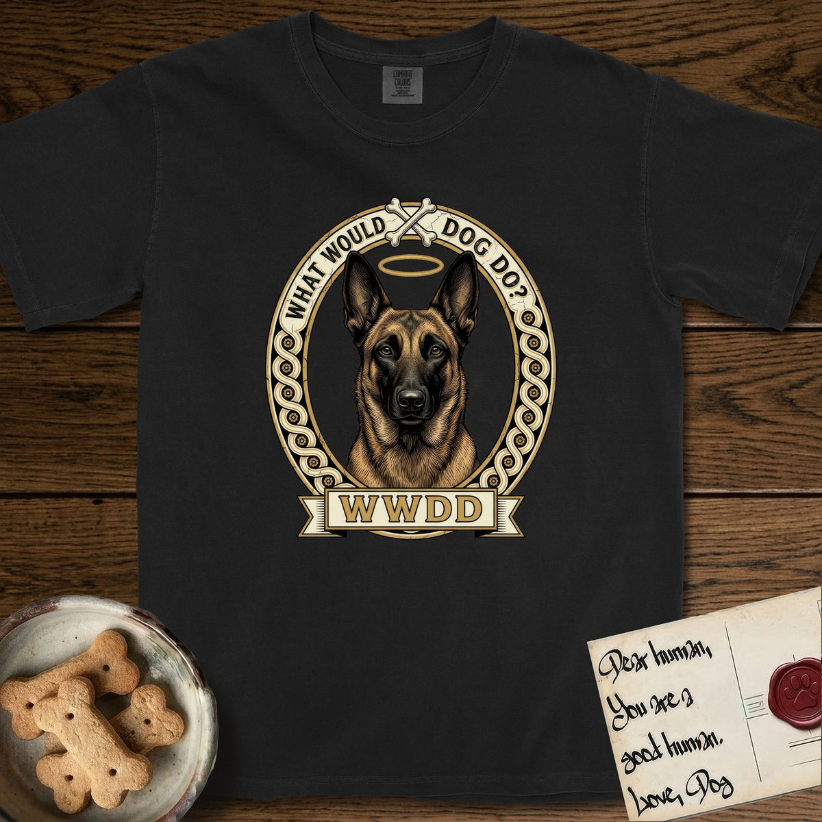 What Would Dog Do Belgian Malinois T-Shirt flat lay in Black, featuring a vintage gold portrait medallion of a haloed Belgian Malinois in an ornamental rosette-scroll border with the question What Would Dog Do.