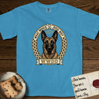 What Would Dog Do Belgian Malinois T-Shirt flat lay in Royal Caribe, featuring a vintage gold portrait medallion of a haloed Belgian Malinois in an ornamental rosette-scroll border with the question What Would Dog Do.