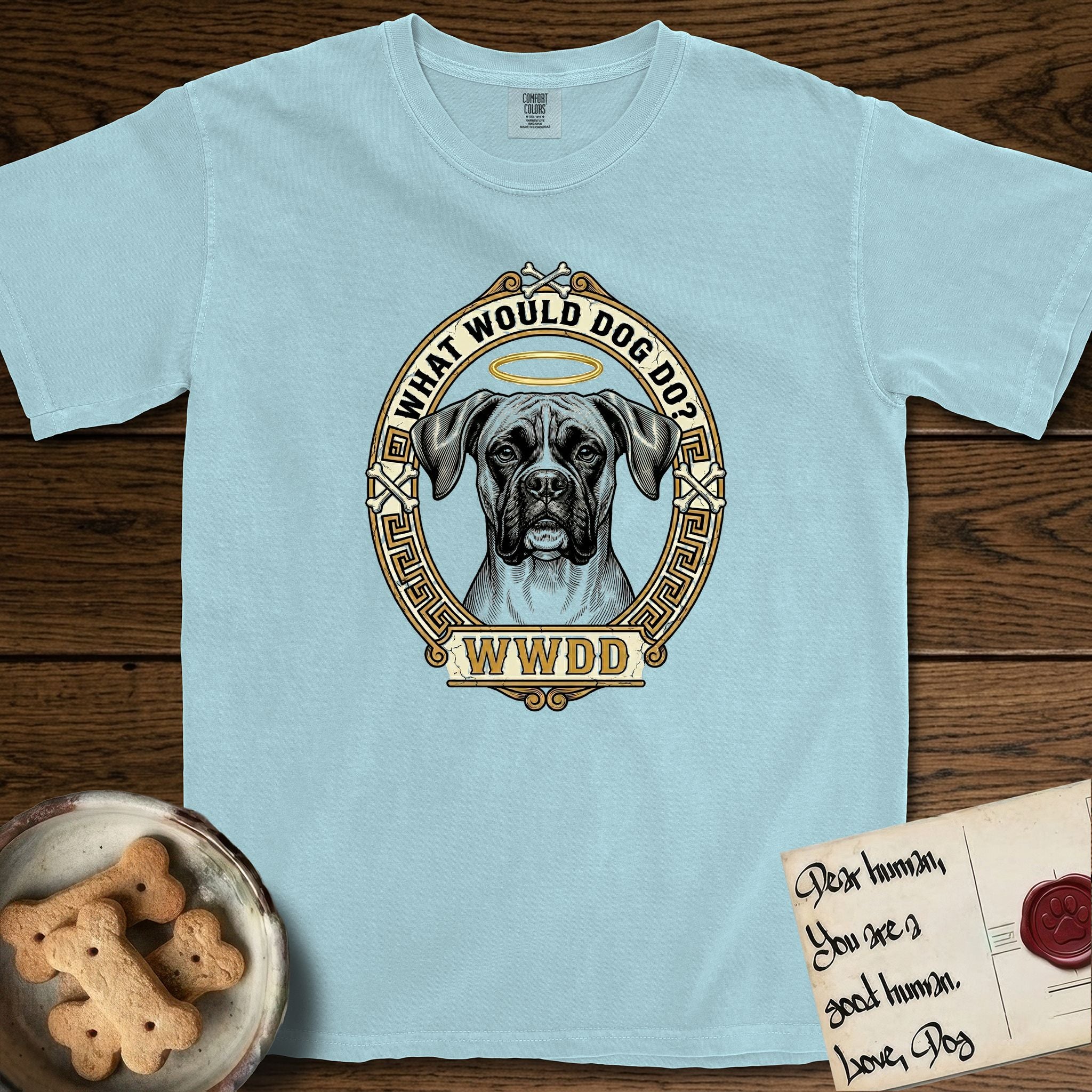 What Would Dog Do Boxer T-Shirt flat lay in Chambray, featuring a Greek-key bordered gold portrait medallion of a haloed Boxer with natural uncropped ears and the question What Would Dog Do.