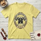 What Would Dog Do Boxer T-Shirt flat lay in Cornsilk, featuring a Greek-key bordered gold portrait medallion of a haloed Boxer with natural uncropped ears and the question What Would Dog Do.