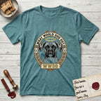 What Would Dog Do Boxer T-Shirt flat lay in Heather Galapagos Blue, featuring a Greek-key bordered gold portrait medallion of a haloed Boxer with natural uncropped ears and the question What Would Dog Do.