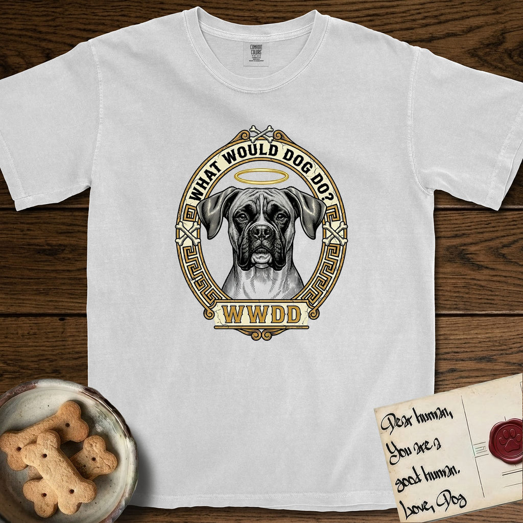 What Would Dog Do Boxer T-Shirt flat lay in White, featuring a Greek-key bordered gold portrait medallion of a haloed Boxer with natural uncropped ears and the question What Would Dog Do.