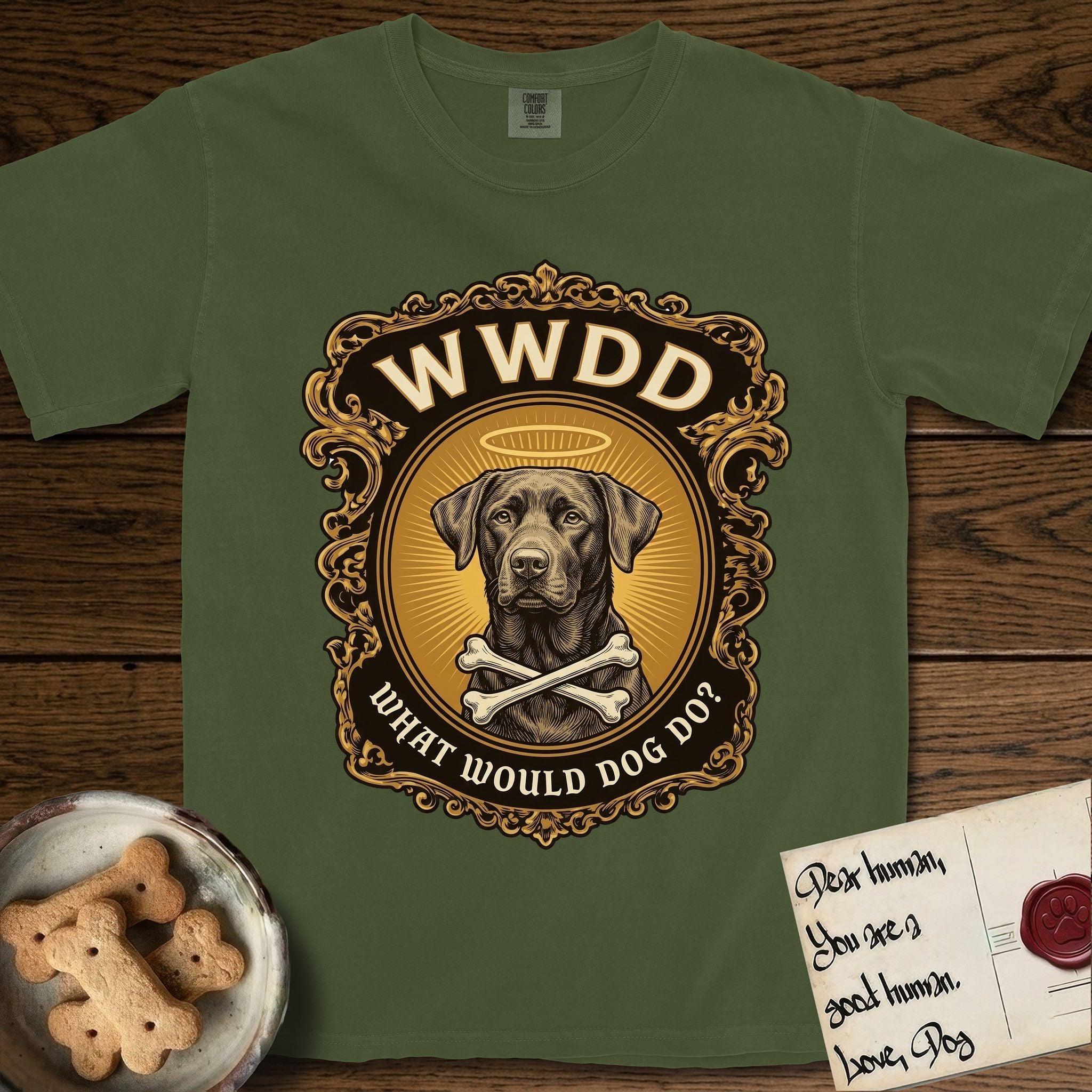 What Would Dog Do Chocolate Lab T-Shirt flat lay in Hemp, featuring a baroque gold ornate portrait medallion of a haloed Chocolate Lab with the question What Would Dog Do.