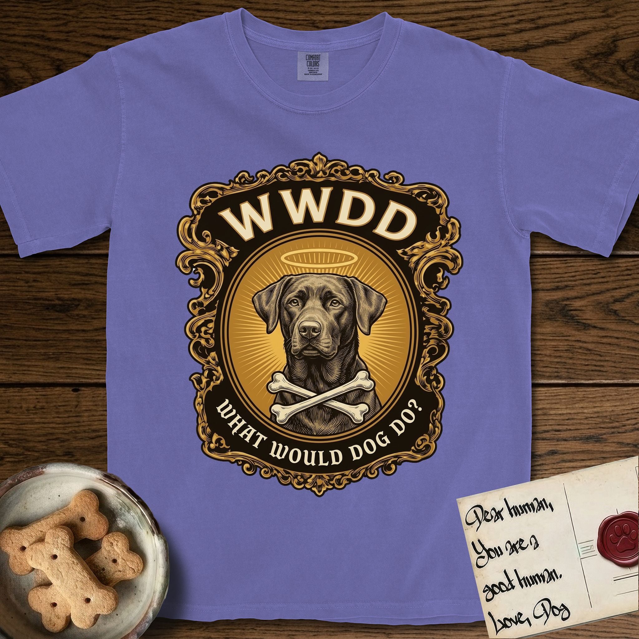 What Would Dog Do Chocolate Lab T-Shirt flat lay in Violet, featuring a baroque gold ornate portrait medallion of a haloed Chocolate Lab with the question What Would Dog Do.