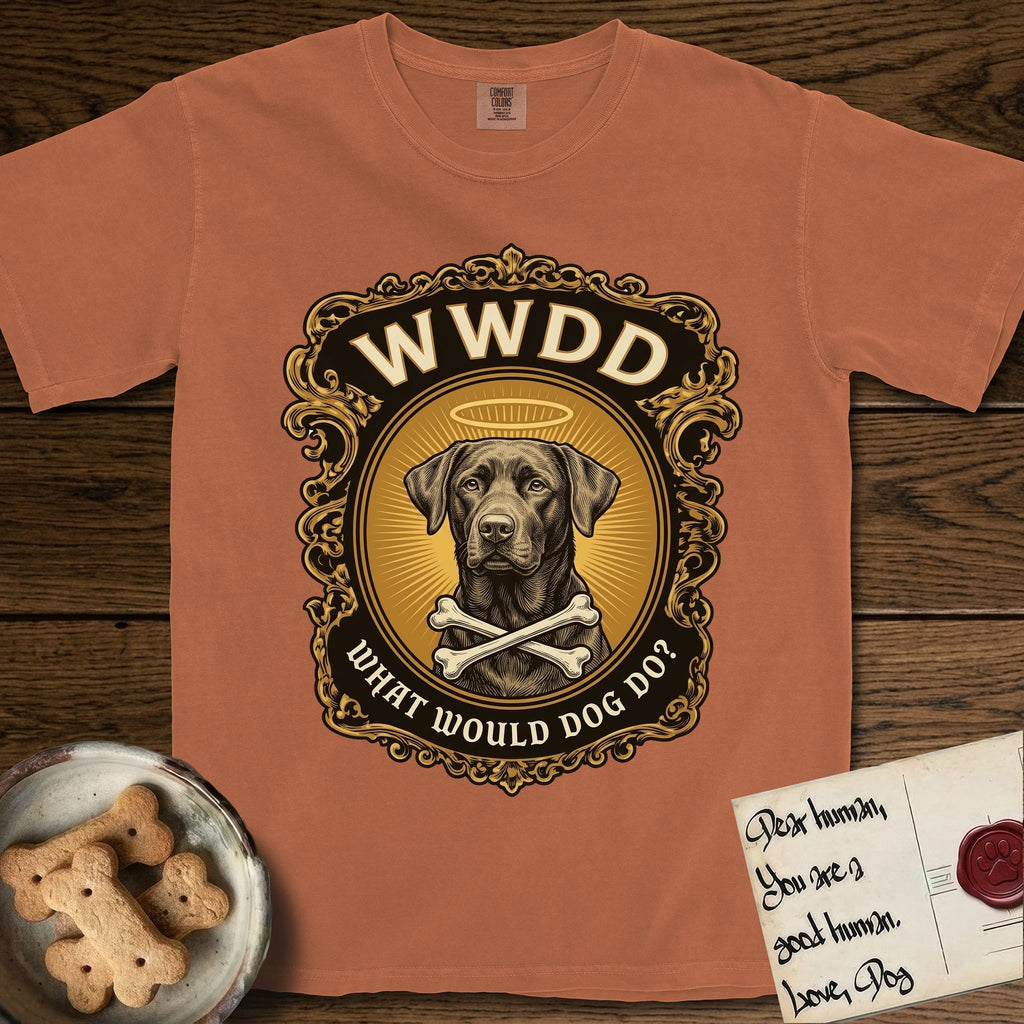 What Would Dog Do Chocolate Lab T-Shirt flat lay in Yam, featuring a baroque gold ornate portrait medallion of a haloed Chocolate Lab with the question What Would Dog Do.