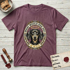 What Would Dog Do Dachshund T-Shirt flat lay in Heather Maroon, featuring an oak-leaf and acorn framed gold portrait medallion of a haloed Dachshund with the question What Would Dog Do.