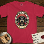 What Would Dog Do Dachshund T-Shirt flat lay in Red, featuring an oak-leaf and acorn framed gold portrait medallion of a haloed Dachshund with the question What Would Dog Do.