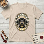 What Would Dog Do Dachshund T-Shirt flat lay in Sand, featuring an oak-leaf and acorn framed gold portrait medallion of a haloed Dachshund with the question What Would Dog Do.