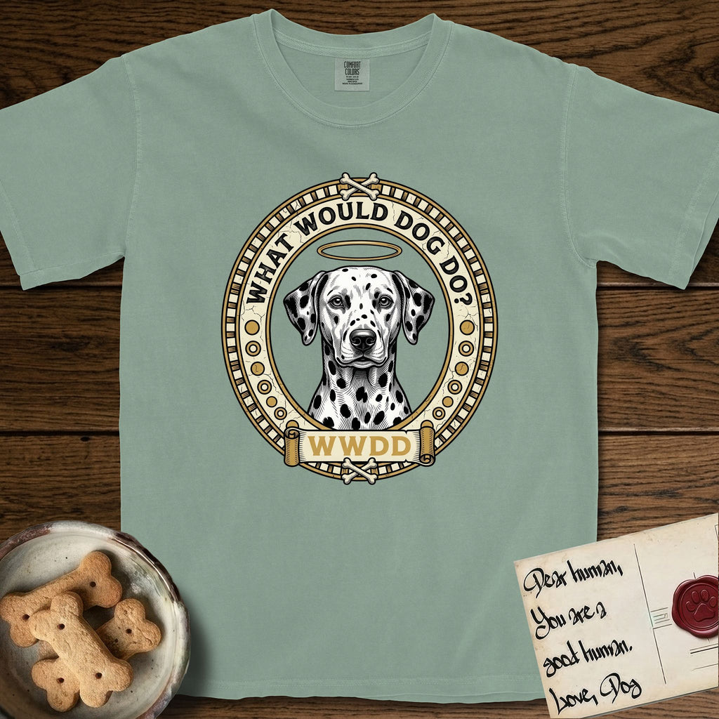 What Would Dog Do Dalmatian T-Shirt flat lay in Bay, featuring a vintage gold portrait medallion of a haloed Dalmatian in an engraved coin-style dotted border with the question What Would Dog Do.