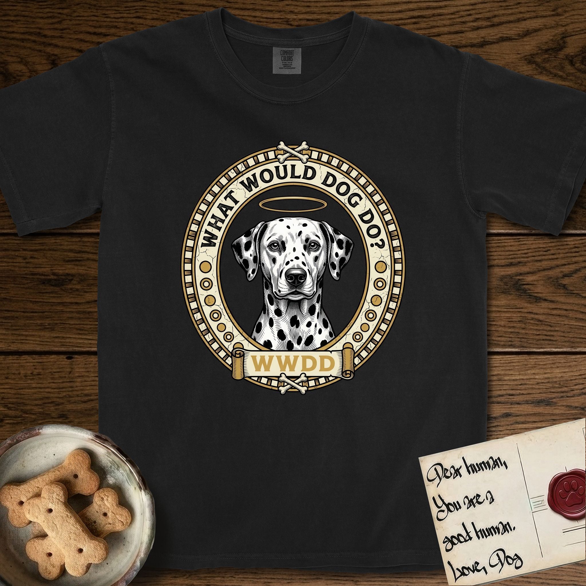 What Would Dog Do Dalmatian T-Shirt flat lay in Black, featuring a vintage gold portrait medallion of a haloed Dalmatian in an engraved coin-style dotted border with the question What Would Dog Do.