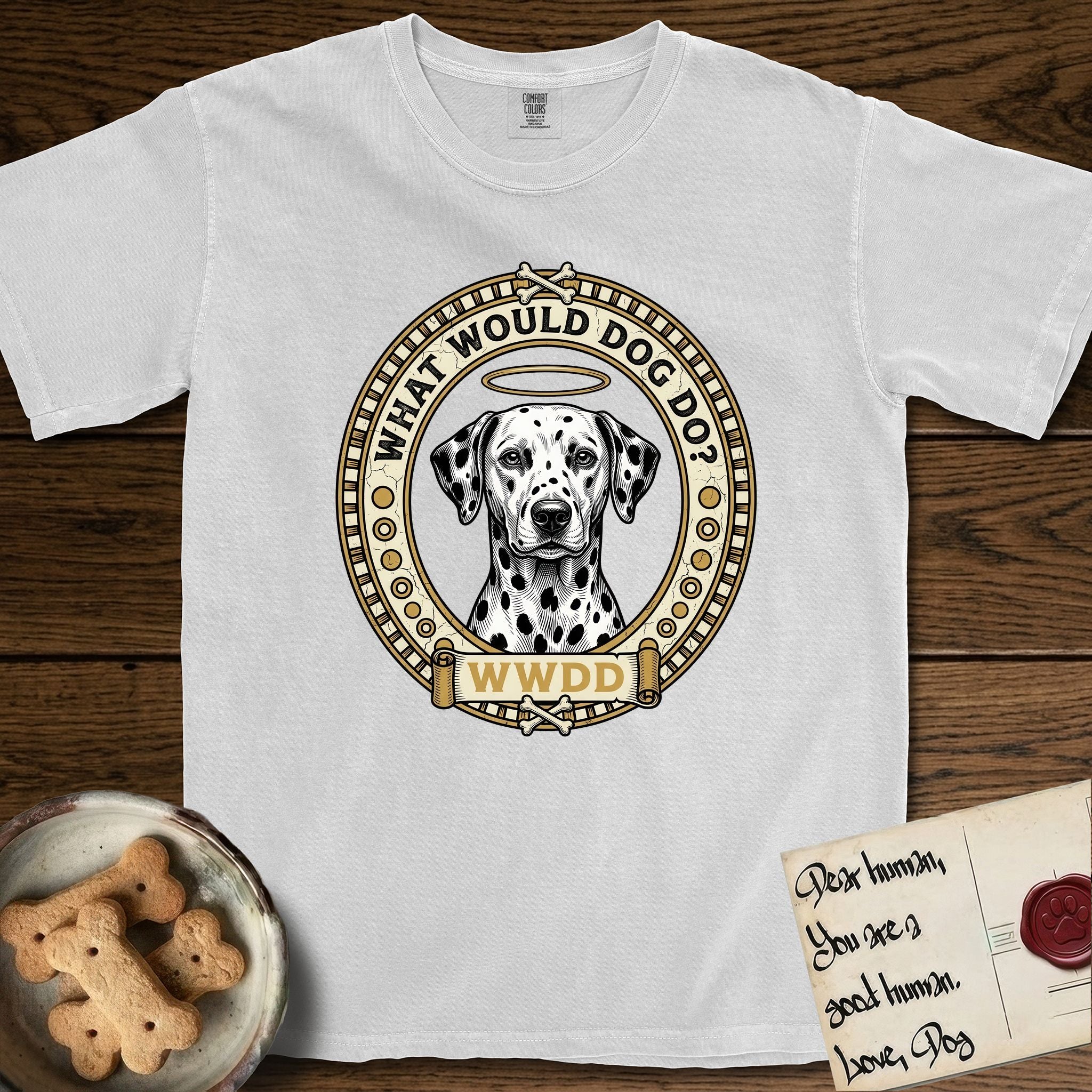 What Would Dog Do Dalmatian T-Shirt flat lay in White, featuring a vintage gold portrait medallion of a haloed Dalmatian in an engraved coin-style dotted border with the question What Would Dog Do.