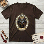 What Would Dog Do Doberman T-Shirt flat lay in Dark Chocolate, featuring a fleur-de-lis framed gold portrait medallion of a haloed Doberman with natural uncropped ears and the question What Would Dog Do.