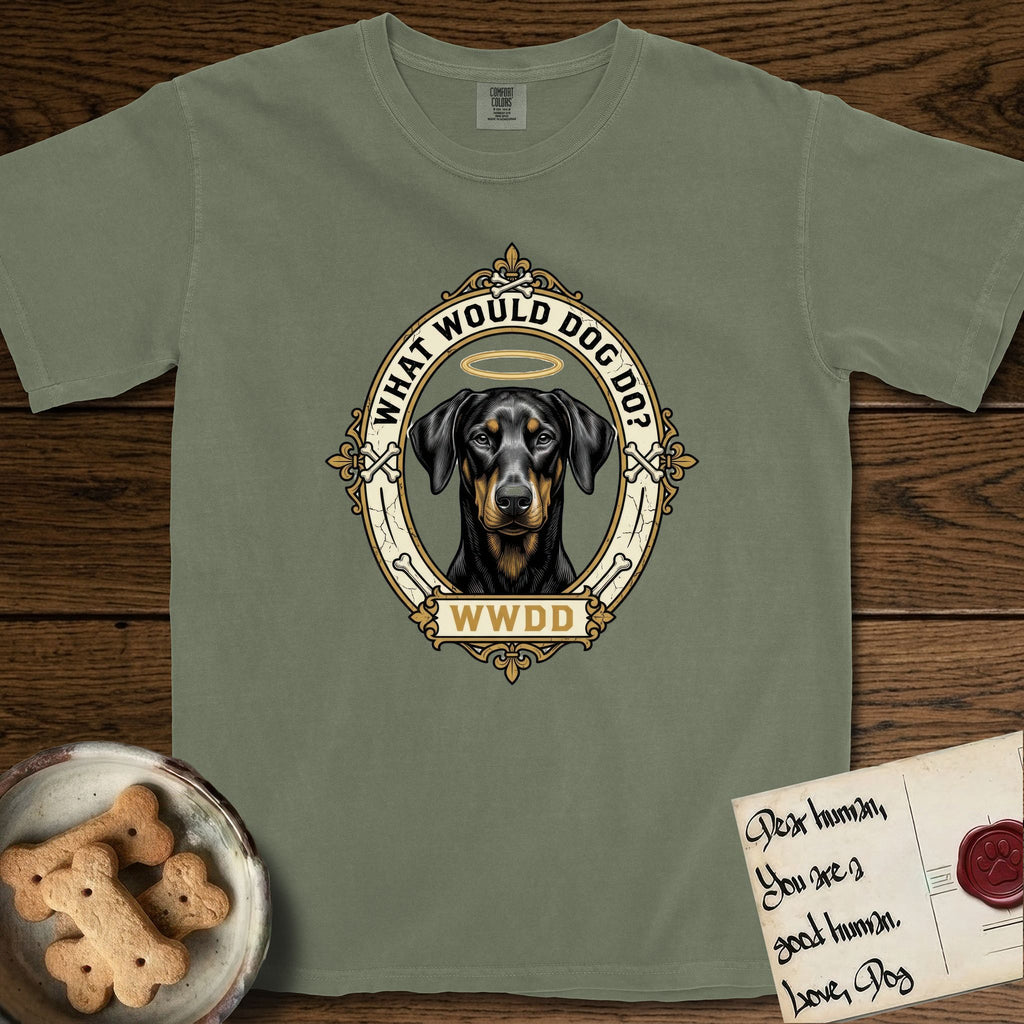 What Would Dog Do Doberman T-Shirt flat lay in Sage, featuring a fleur-de-lis framed gold portrait medallion of a haloed Doberman with natural uncropped ears and the question What Would Dog Do.