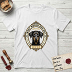 What Would Dog Do Doberman T-Shirt flat lay in White, featuring a fleur-de-lis framed gold portrait medallion of a haloed Doberman with natural uncropped ears and the question What Would Dog Do.